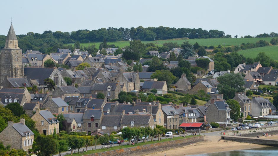 Picturesque view of Saint-Suliac village with historic architecture and lush greenery